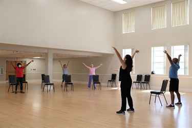 Seniors exercising in a fitness class at a neighborhood center