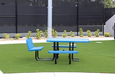 A blue bench with a table