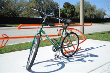 Bike parked by the helicopter shaped bike rack