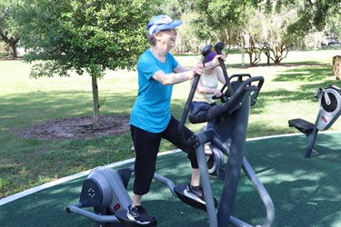 Residents using outdoor fitness stations to exercise