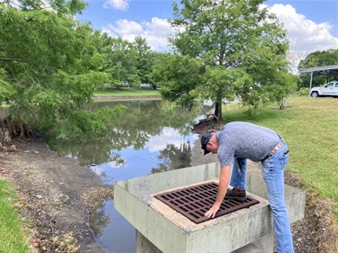 Man inspecting pond