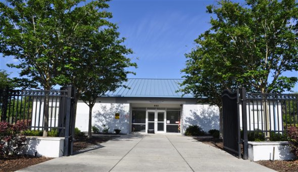 Tree-lined walkway leading up to Rock Lake Neighborhood Center.