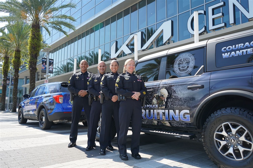 Recruiting officers from OPD in front of a police car