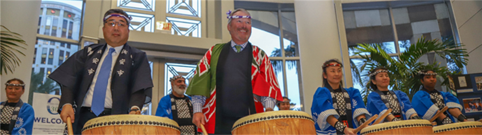 Mayor Dyer playing drums with the mayor of Urayasu